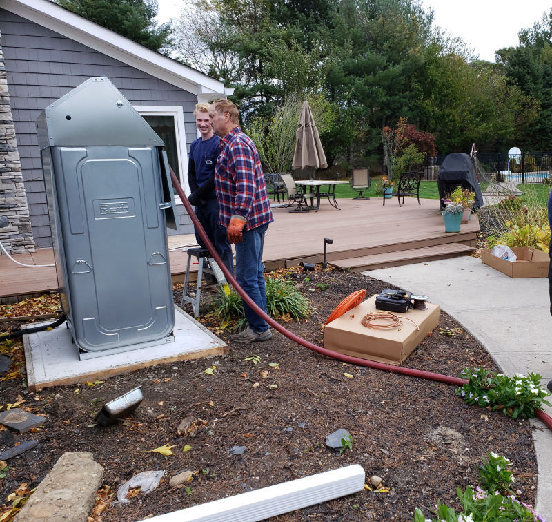 Outdoor Roth tank being filled with oil after installation