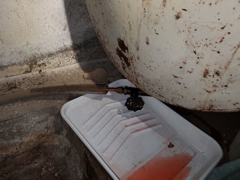Heating oil leaking from an oil tank into a drip pan